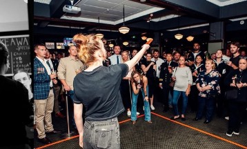 Brydie pointing into a crowd from the floor